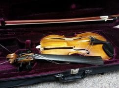A precious violin is crushed on a NY garage floor