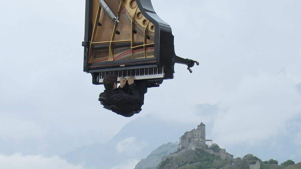 A performing pianist is suspended in mid-air