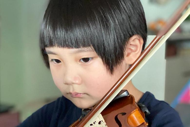 Child, 5, passes grade 8 violin before he can write