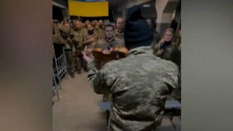 A Ukraine soldier plays violin to his unit
